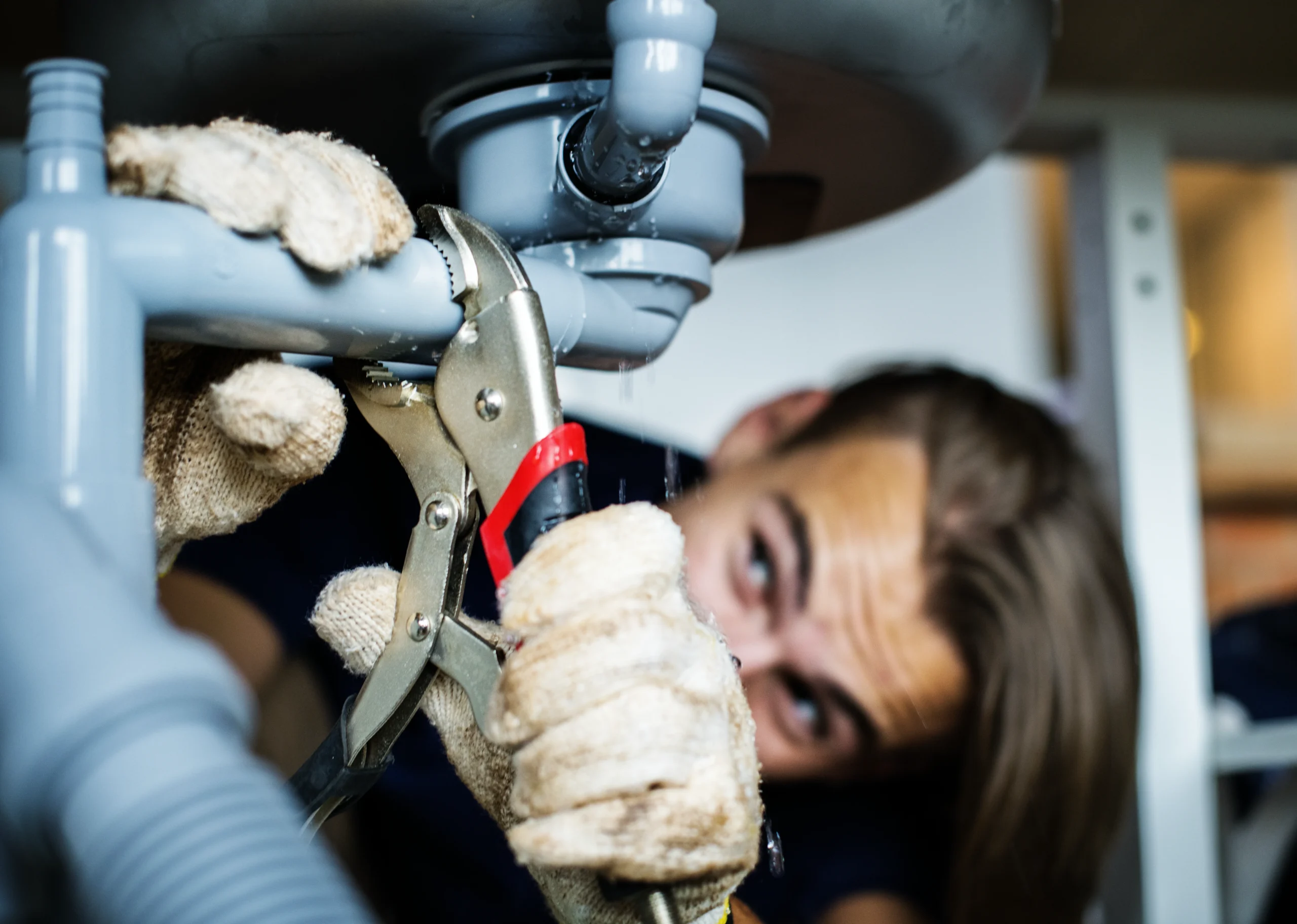 man-fixing-kitchen-sink commercial plumbing